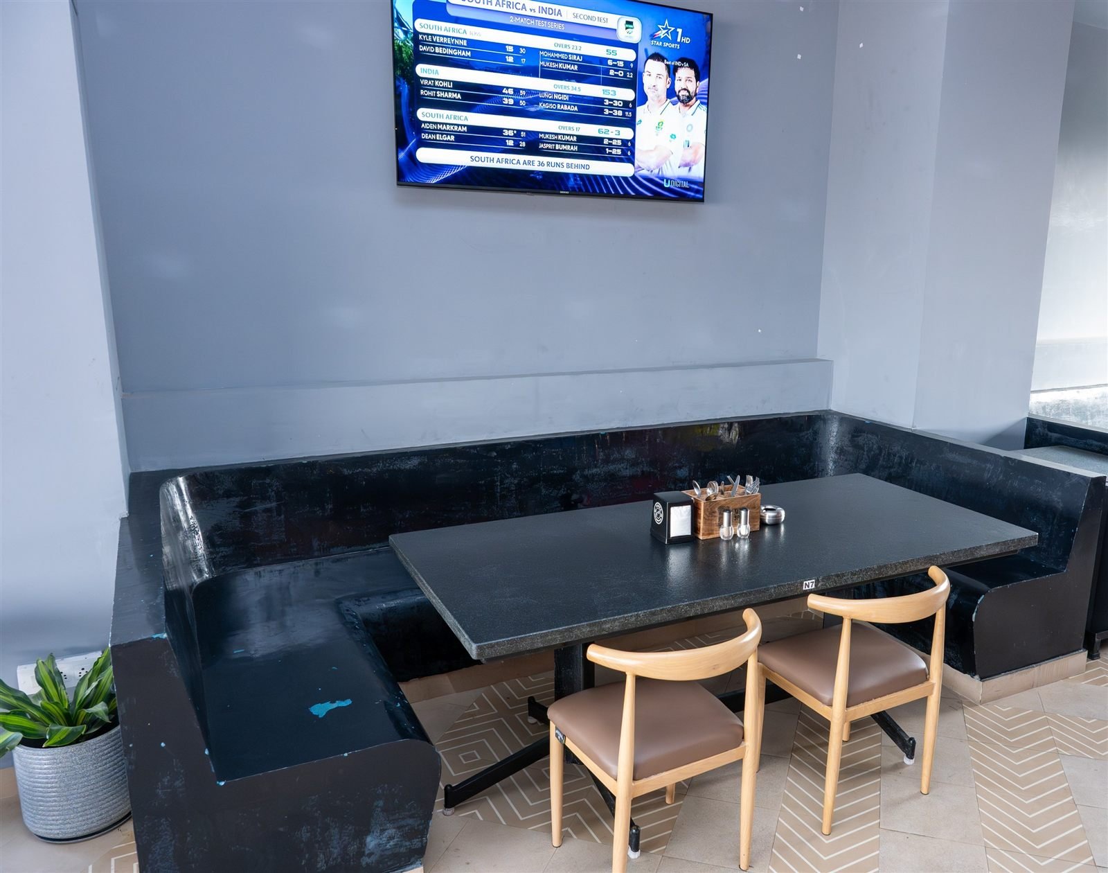 A corner table beneath a wall-mounted television