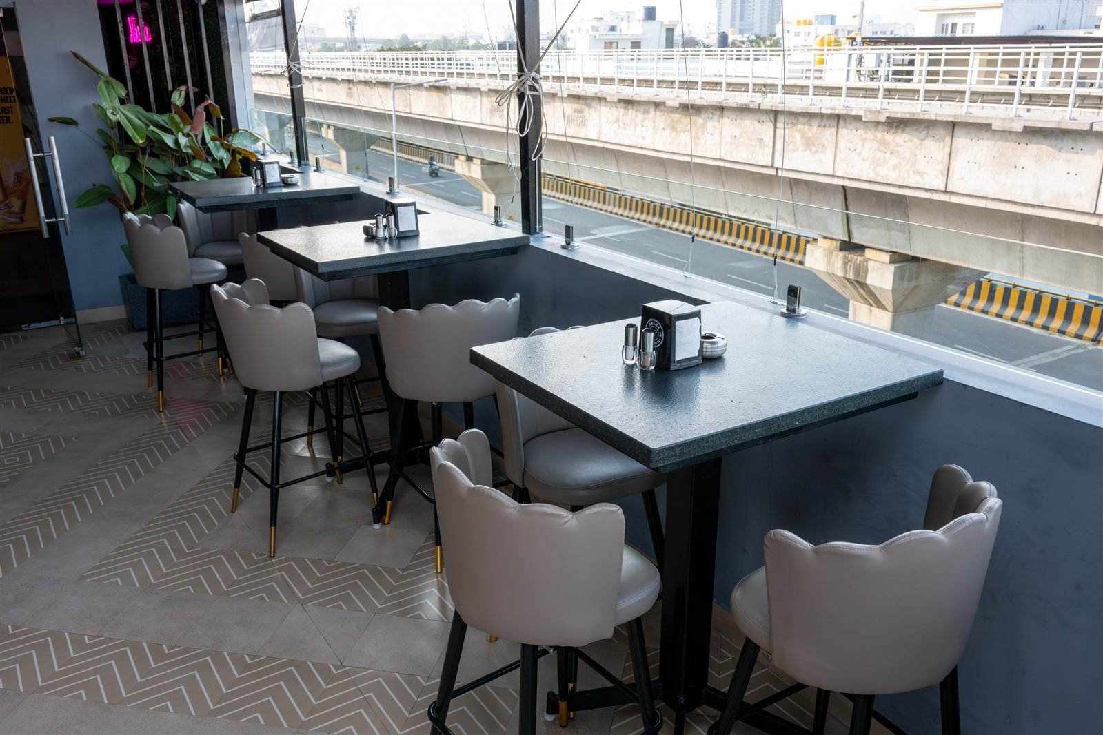 High tables and stools beside the windows