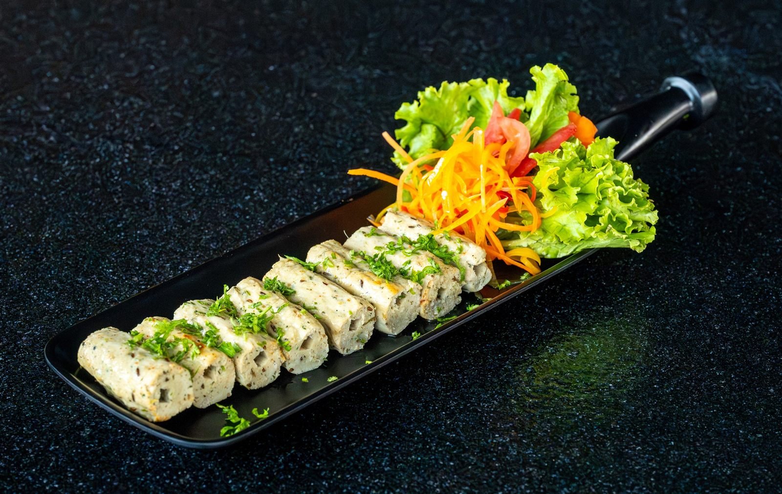 Sliced rolls served on a long platter with salad