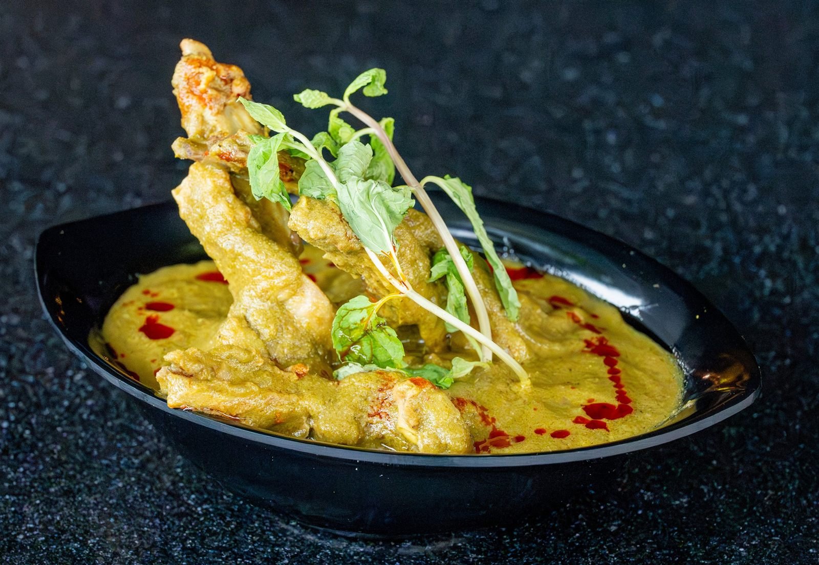 Chicken in a pale green gravy