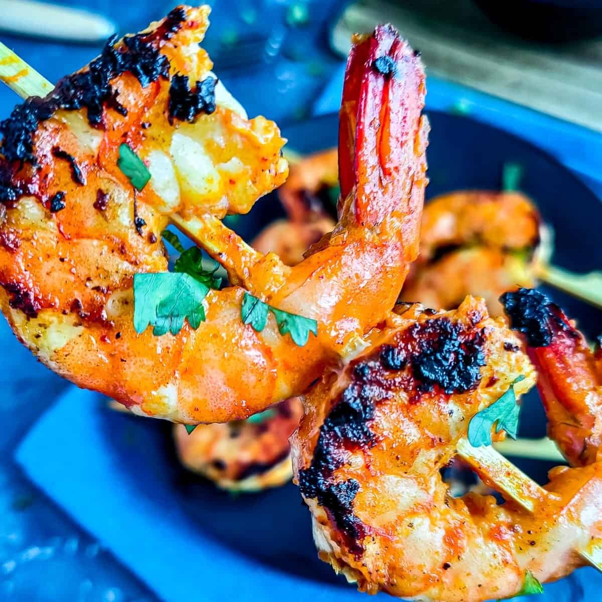 Charred tandoori prawns on skewers